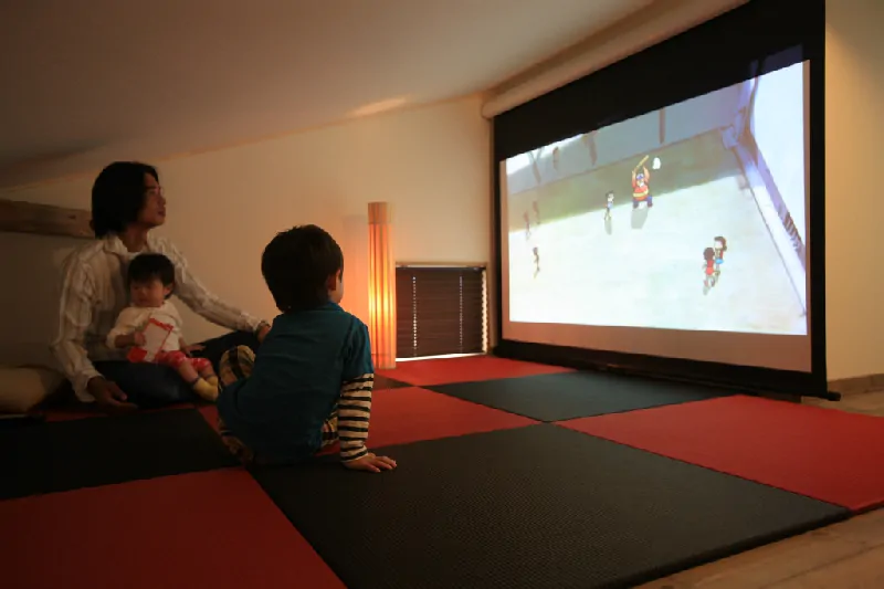 小屋裏部屋で映画鑑賞を楽しむ親子